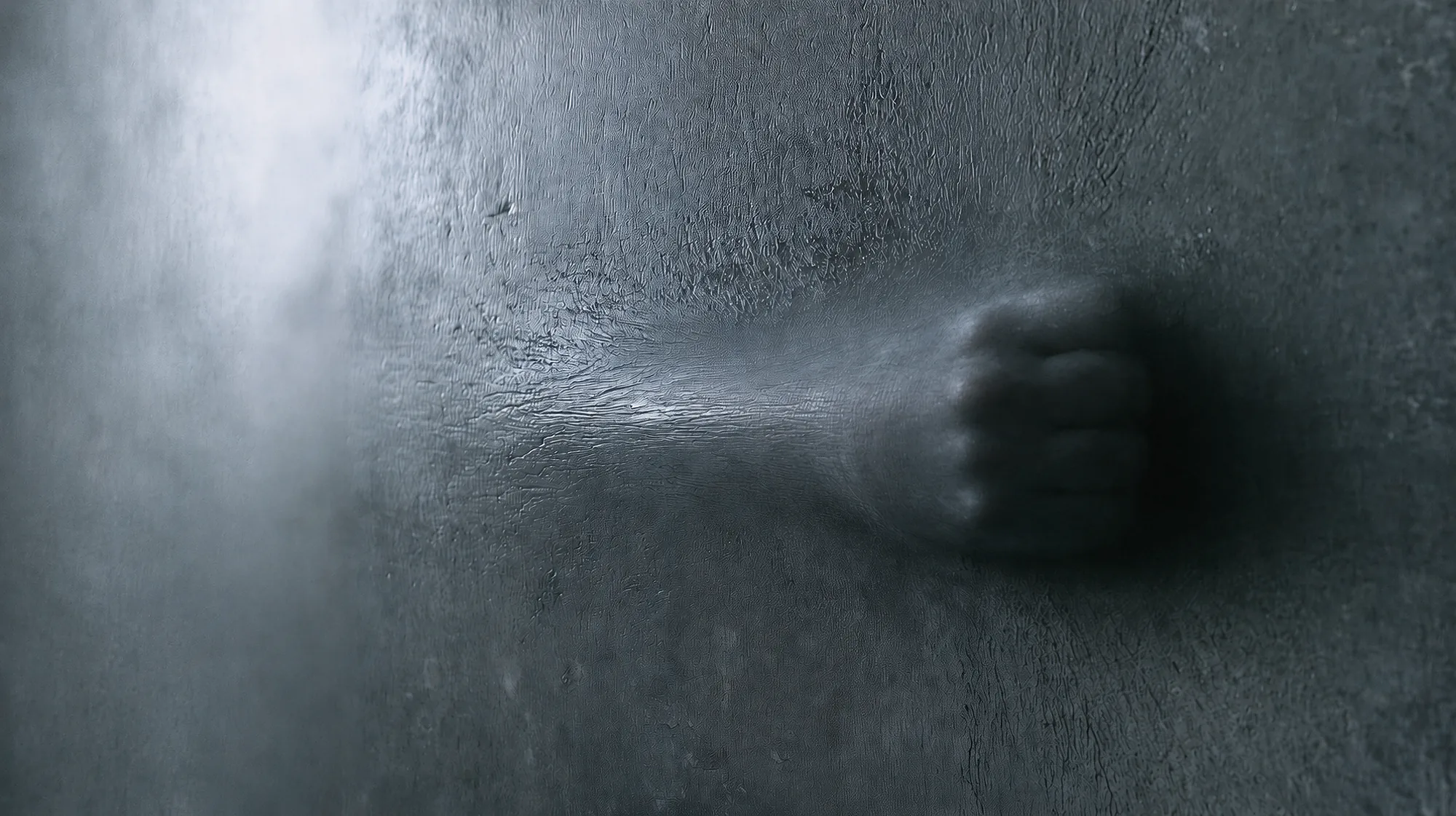 A clenched fist presses against the Membrane from within; the surface does not rupture, but retains the trace of the force.